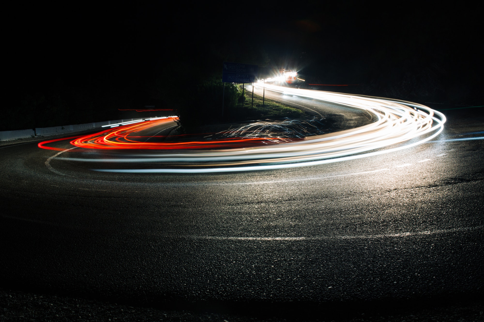 Bright car lines on night road